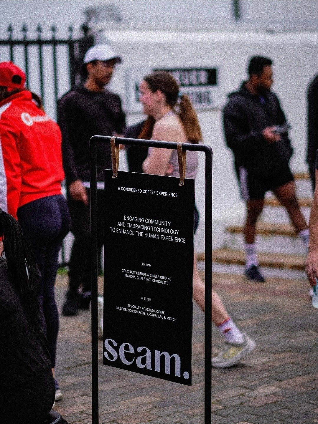 Runners gathering beside the Seam Coffee sign